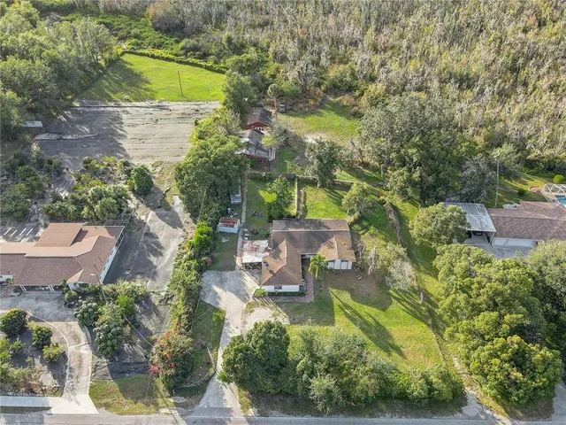 an aerial view of a house with a yard basket ball court and outdoor seating
