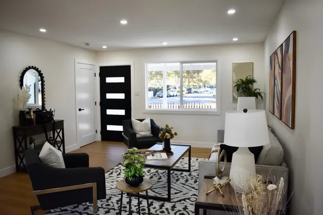 a living room with furniture and wooden floor