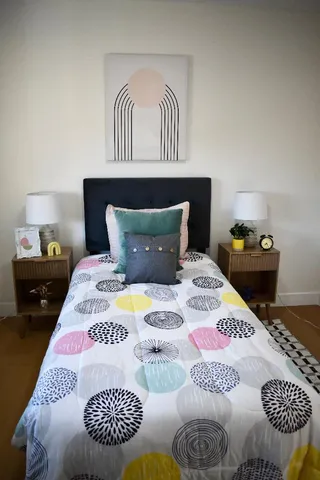 a bedroom with a bed and dresser