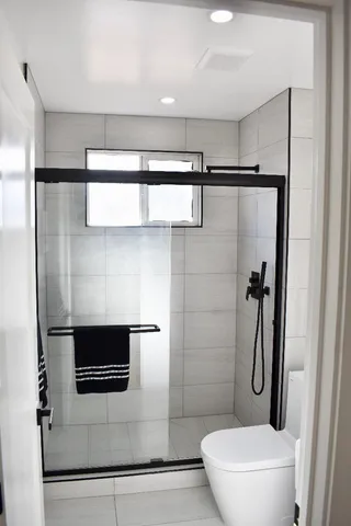 a bathroom with a shower and a toilet