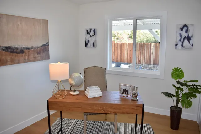 a table with a potted plant on a table and a window