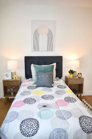 a bedroom with a bed and a table in it