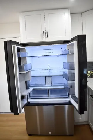 a view of a room with wooden floor and cabinets