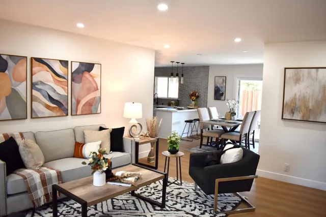 a living room with furniture and wooden floor