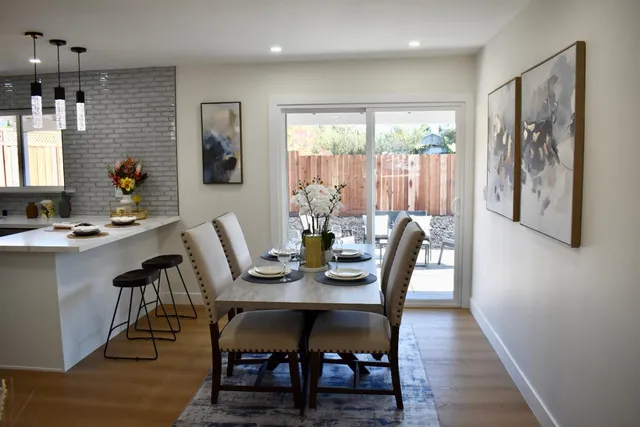 a view of a dining room with furniture and wooden floor