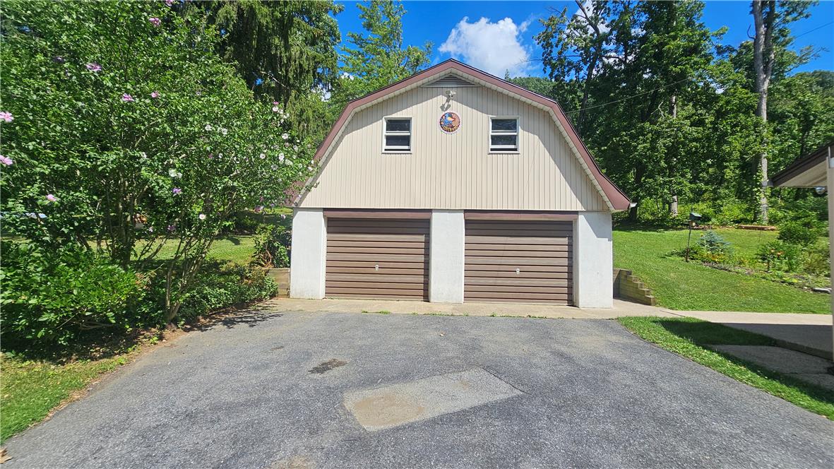 2529 Ringhoffer Road Hellertown, PA 18055 - Photo 23 of 33 A two-car garage with a charming second-story loft sits nestled among verdant landscaping.