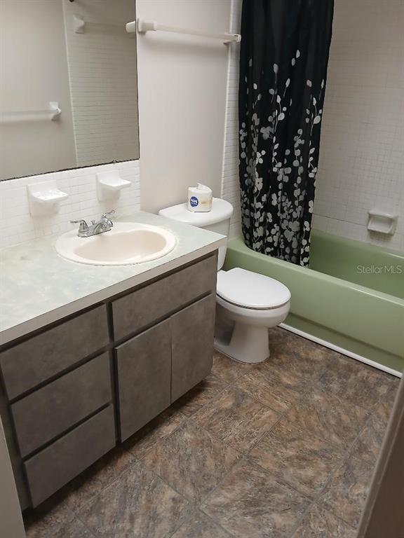 1433 South Belcher Road, Unit F5 Clearwater, FL 33764 - Photo 11 of 18 a bathroom with a sink a toilet and shower