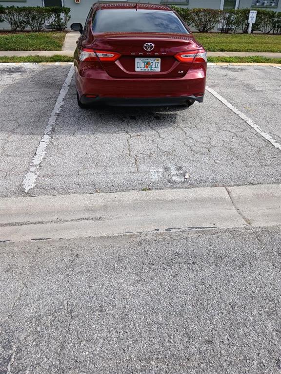 1433 South Belcher Road, Unit F5 Clearwater, FL 33764 - Photo 13 of 18 a view of a yard with a car parked