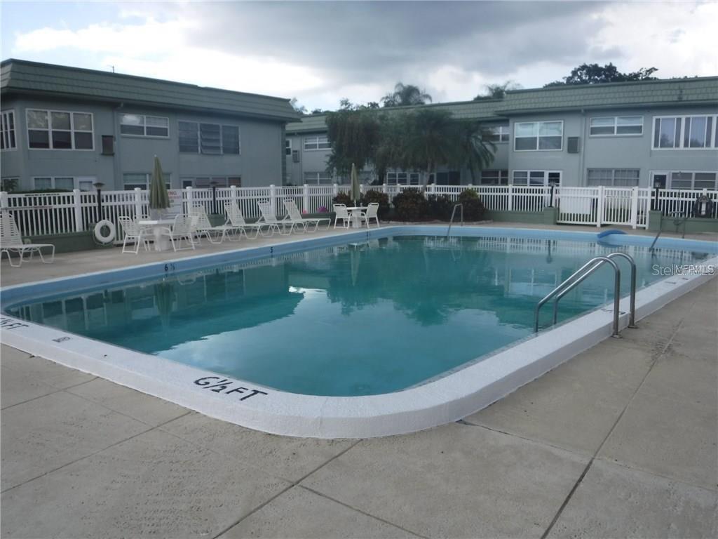 1433 South Belcher Road, Unit F5 Clearwater, FL 33764 - Photo 15 of 18 a view of a swimming pool with outdoor seating
