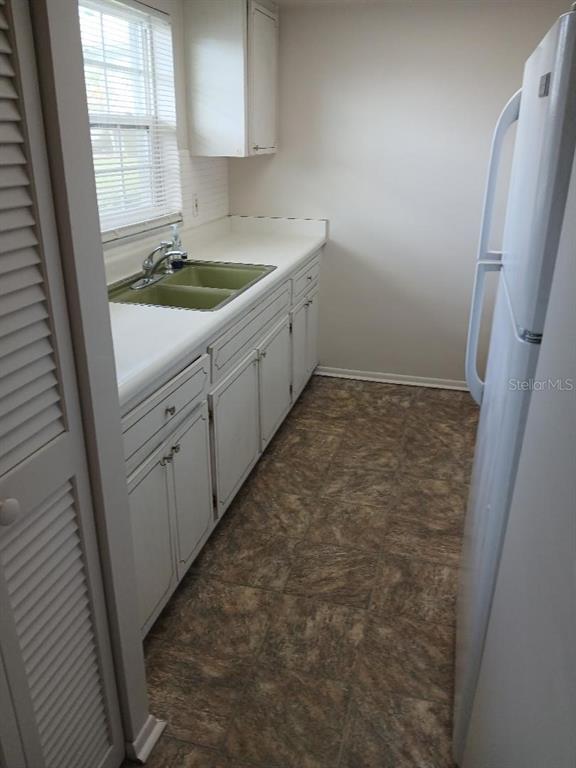 1433 South Belcher Road, Unit F5 Clearwater, FL 33764 - Photo 8 of 18 a bathroom with a sink a toilet and a window