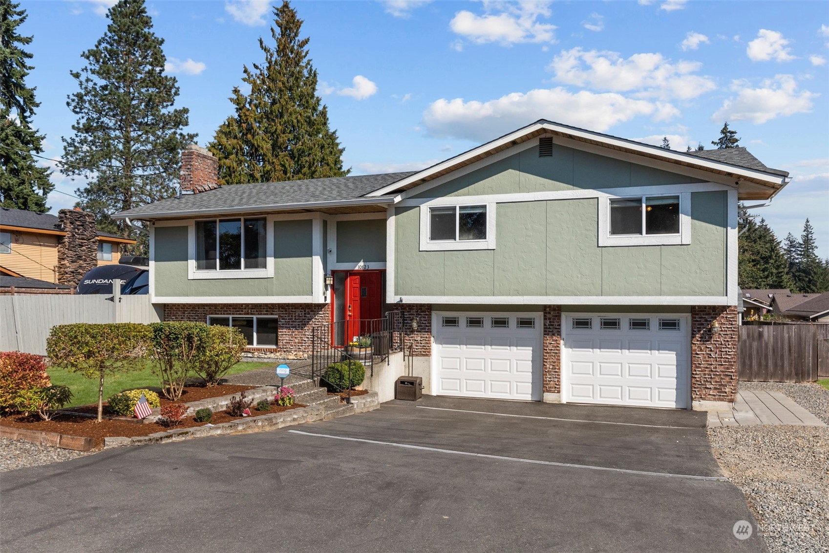 a front view of a house with a yard and garage
