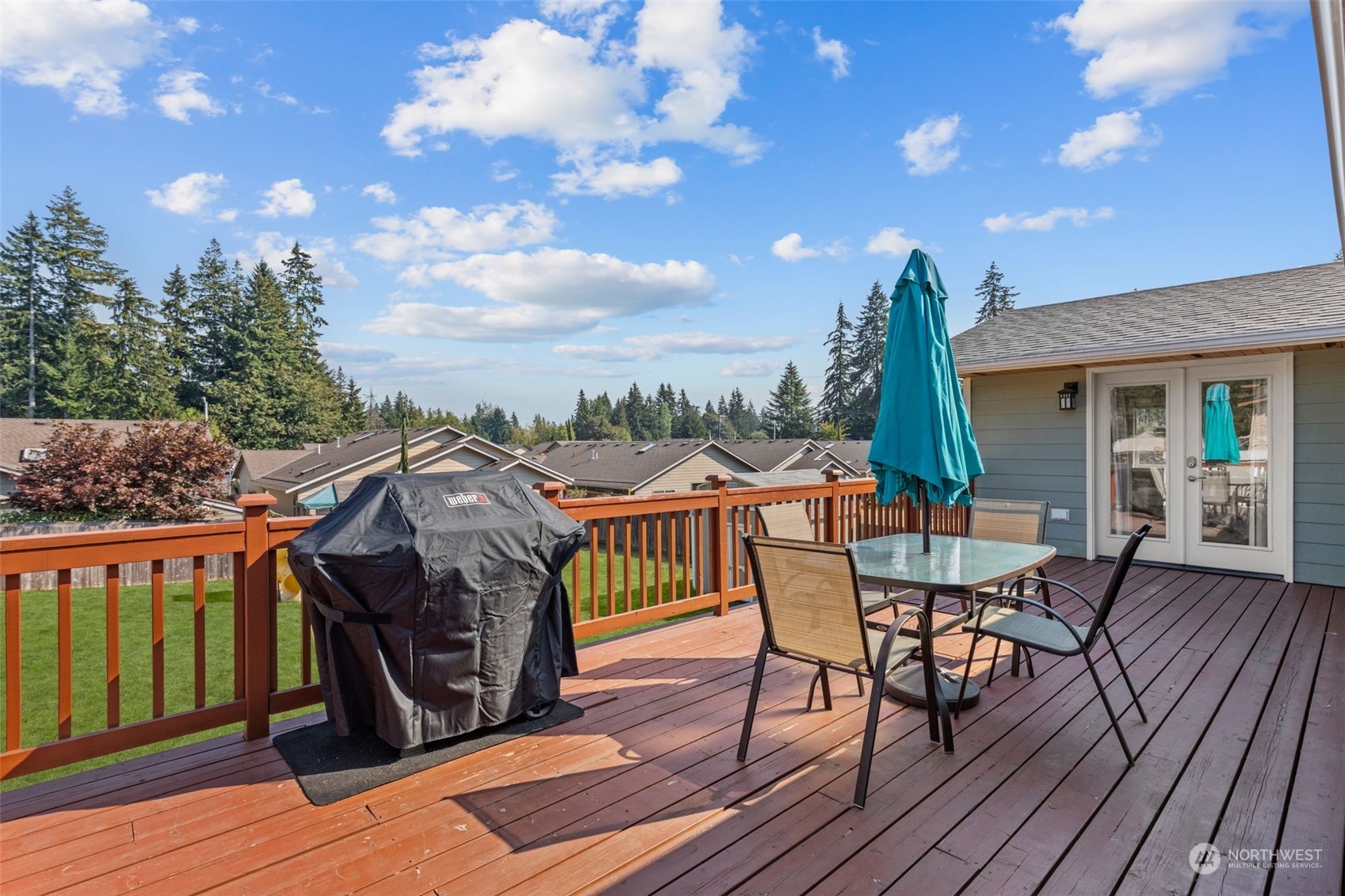 10823 23rd Drive Southeast Everett, WA 98208 - Photo 12 of 39 a view of a roof deck with table and chairs a barbeque with wooden floor and fence