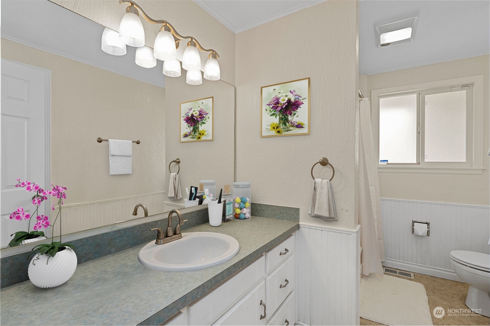 10823 23rd Drive Southeast Everett, WA 98208 - Photo 24 of 39 a bathroom with a granite countertop sink a toilet and a mirror