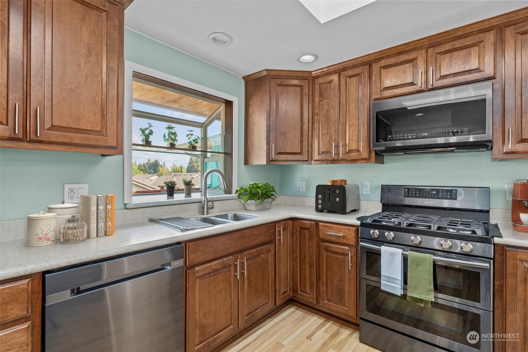 10823 23rd Drive Southeast Everett, WA 98208 - Photo 10 of 39 a kitchen with stainless steel appliances white cabinets granite counter tops and a window