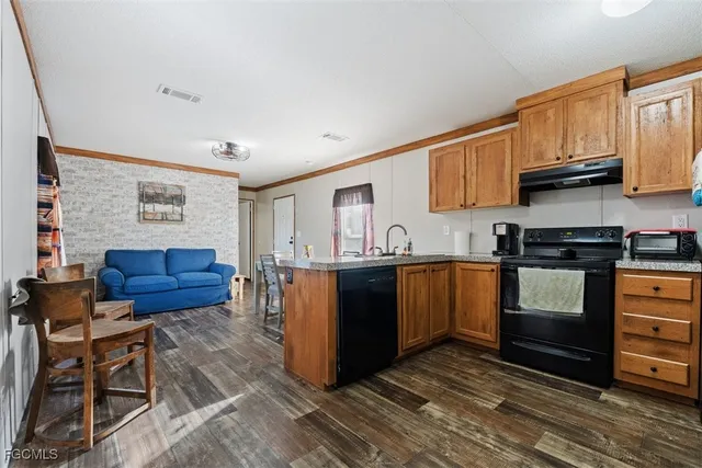 a kitchen with stainless steel appliances granite countertop a stove and a refrigerator