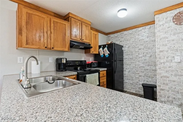 a bathroom with a granite countertop sink and a toilet