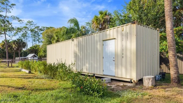 a backyard of a house with table and chairs