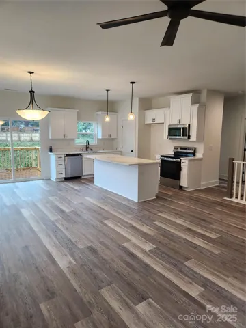 a large kitchen with cabinets a sink and a stove
