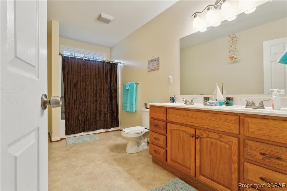 345 Fox Hill Road Hampton, VA 23669 - Photo 21 of 46 Bathroom with a shower with shower curtain, double vanity, toilet, visible vents, and a sink