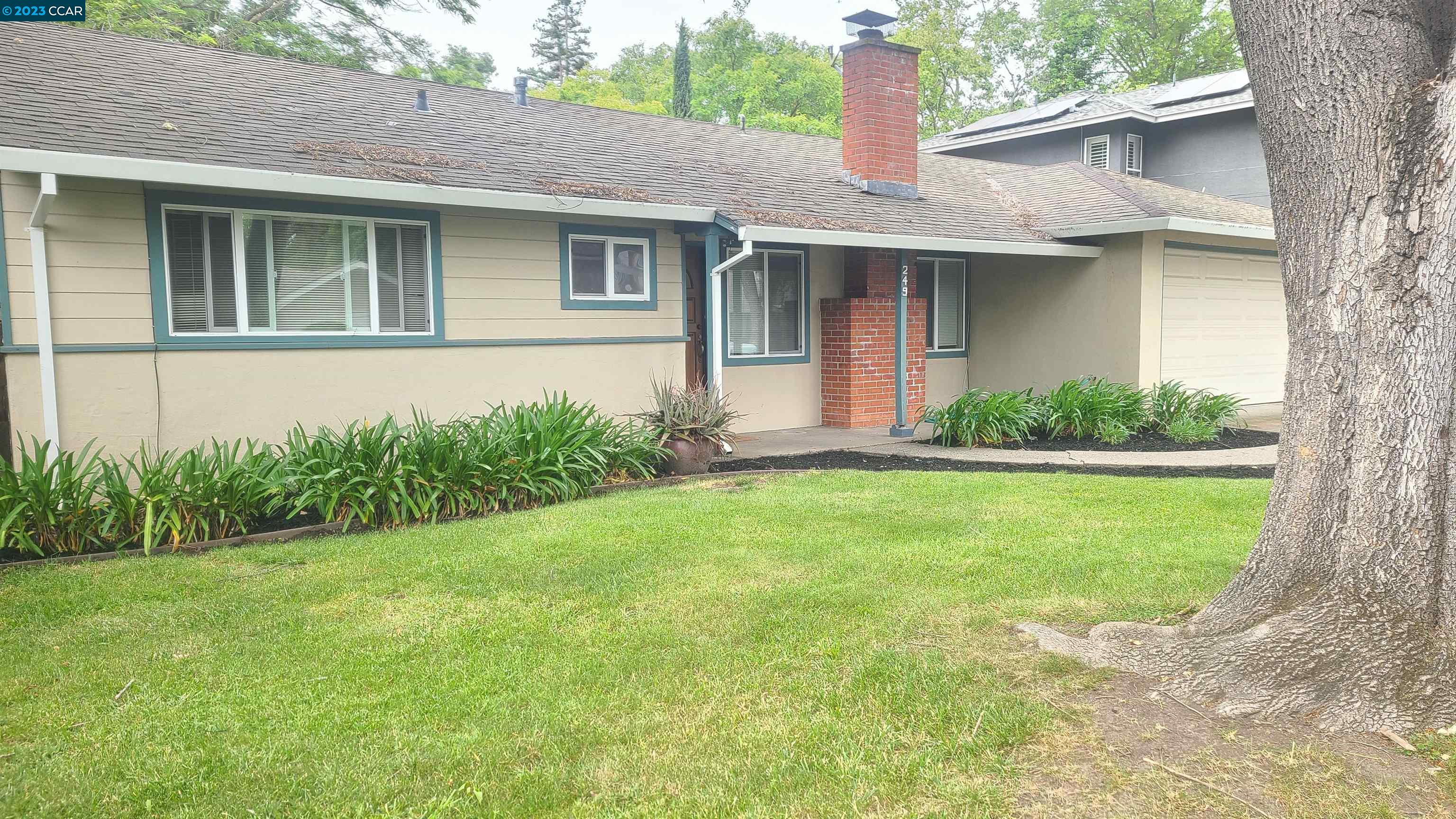 a front view of a house with a yard