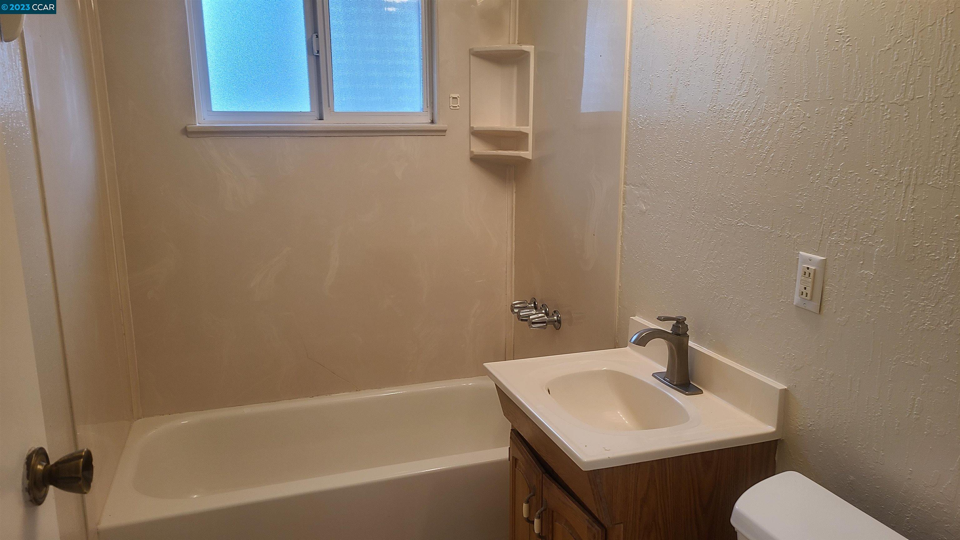 249 Evelyn Drive Pleasant Hill, CA 94523 - Photo 14 of 18 a bathroom with a sink toilet and bathtub