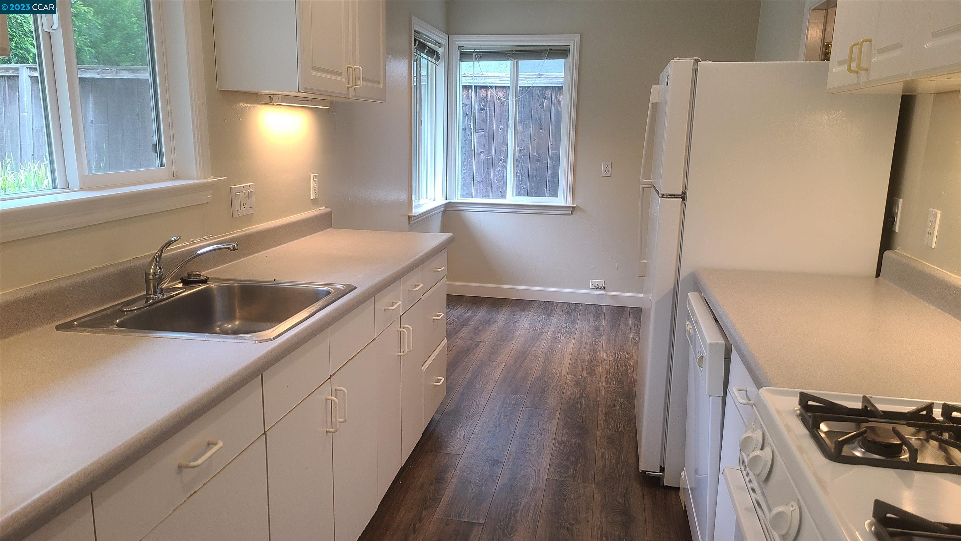 249 Evelyn Drive Pleasant Hill, CA 94523 - Photo 5 of 18 a kitchen with a sink a refrigerator and window