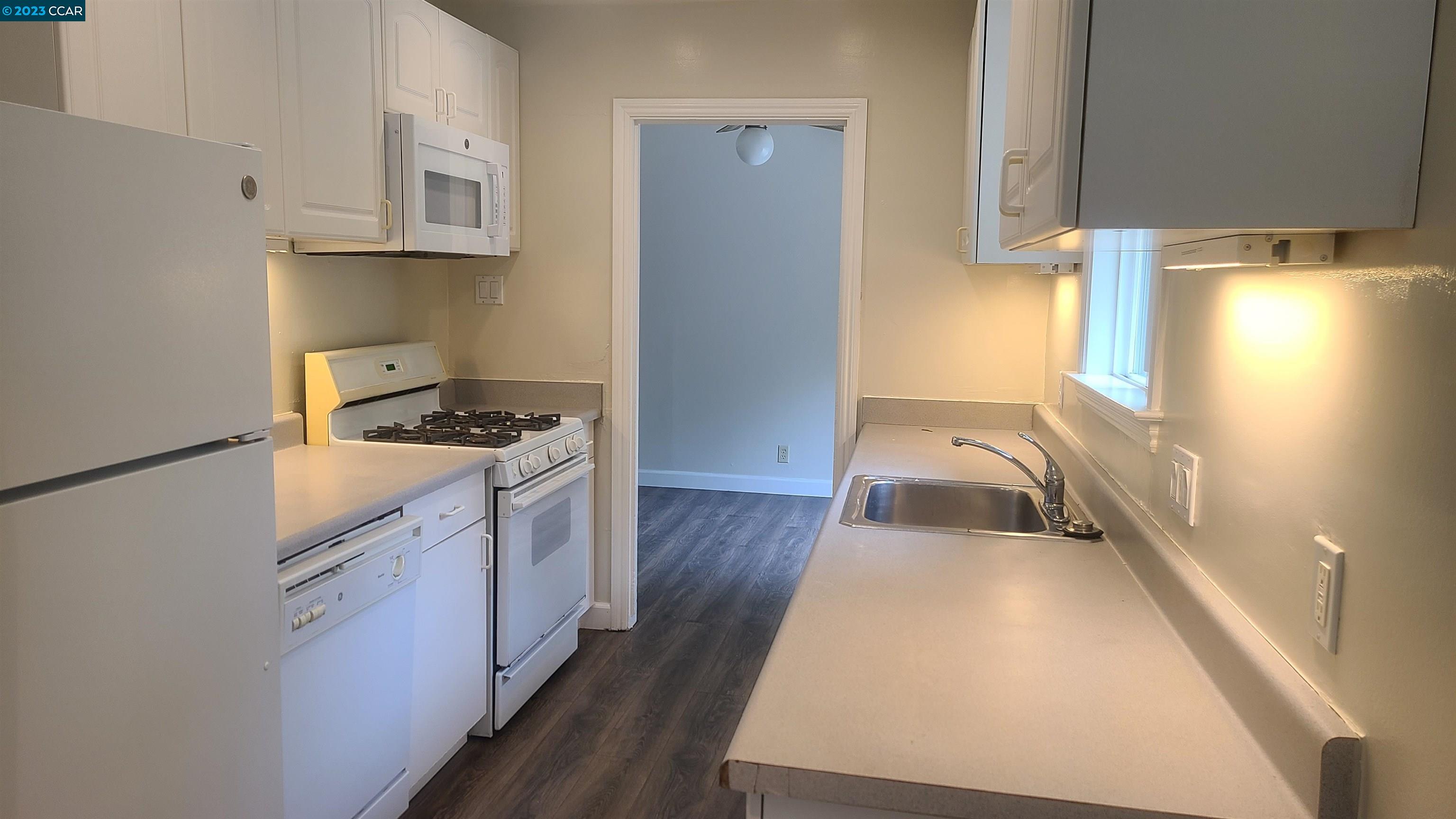 249 Evelyn Drive Pleasant Hill, CA 94523 - Photo 9 of 18 a kitchen with granite countertop a sink a stove and cabinets