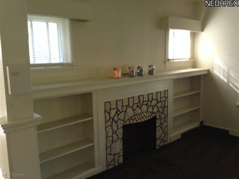 43725 Middle Ridge Road Lorain, OH 44053 - Photo 11 of 25 Living room with built in bookcase and decor. fireplace that you may be able to make electric logs