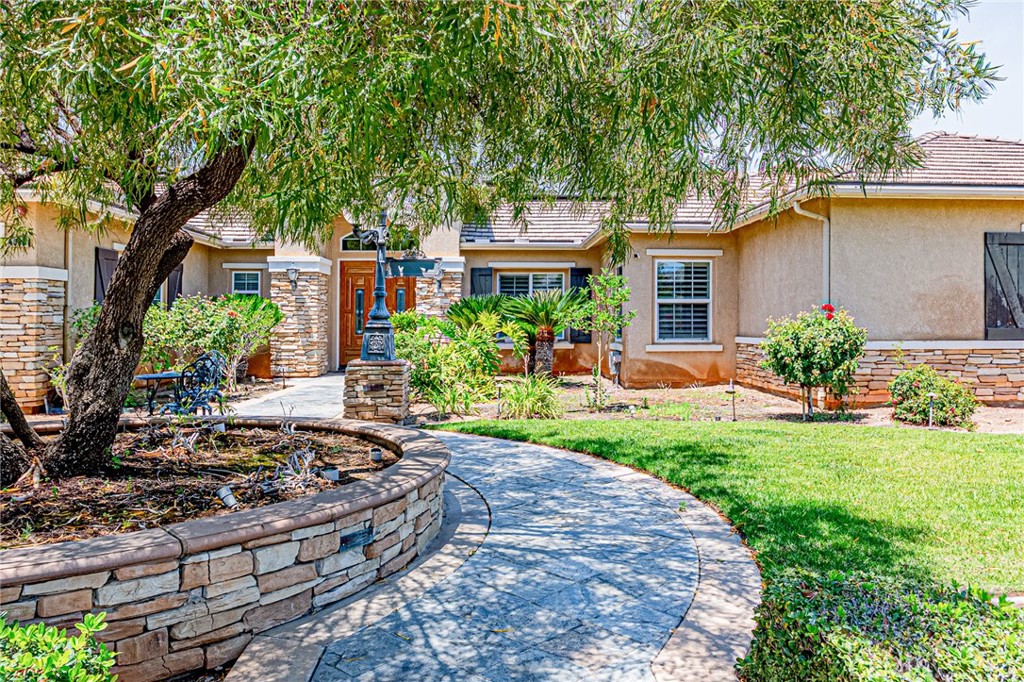 4088 Shady Ridge Circle Corona, CA 92881 - Photo 10 of 47 a front view of a house with a garden