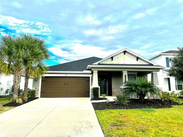 a front view of a house with yard and green space