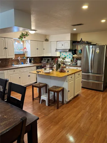 a kitchen with a table chairs stove and cabinets