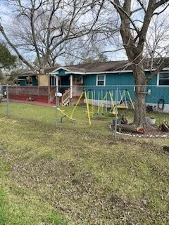 a view of a house with a backyard and a tree