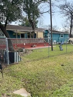 a view of house with a backyard