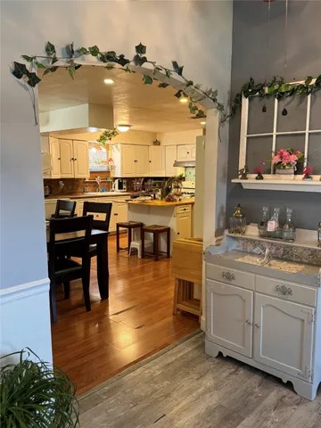 a kitchen with a sink cabinets and wooden floor