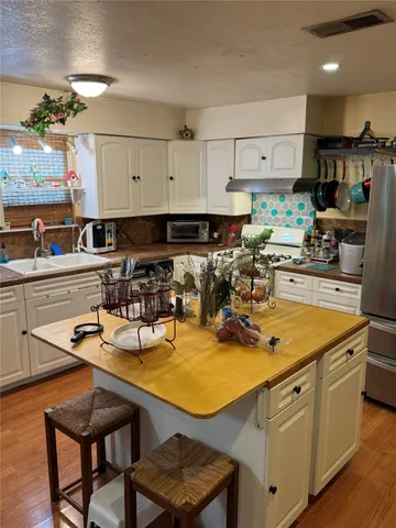 a kitchen with a sink appliances and cabinets