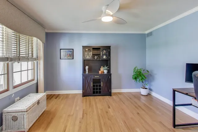 a living room with a bed furniture and a large window