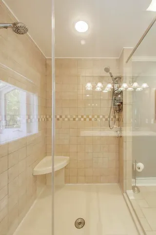 a view of walk in closet with empty room and wooden floor