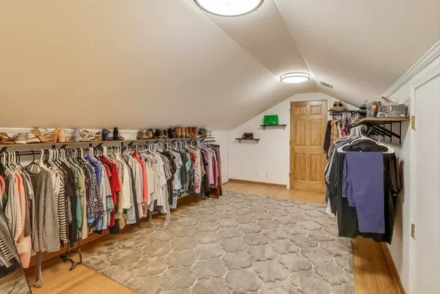 a view of walk in closet with empty racks