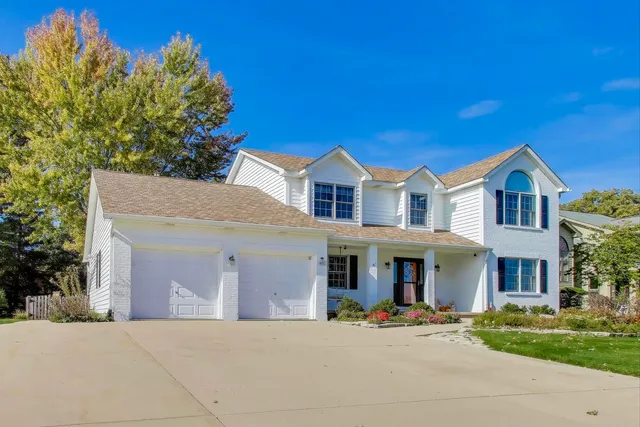 a front view of a residential houses with yard