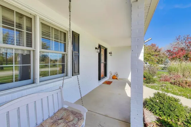 a view of staircase with furniture and a window