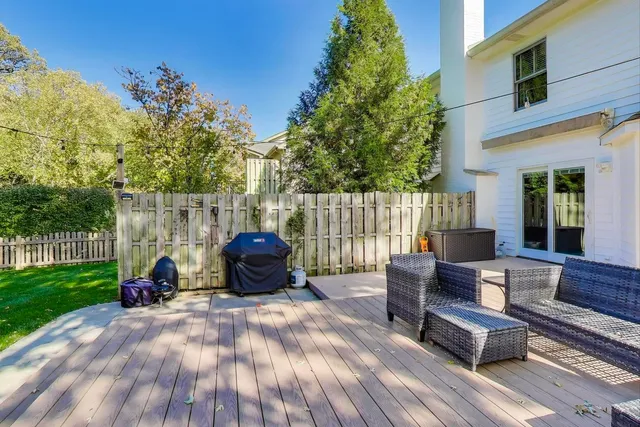 a view of a house with a big yard potted plants and large tree