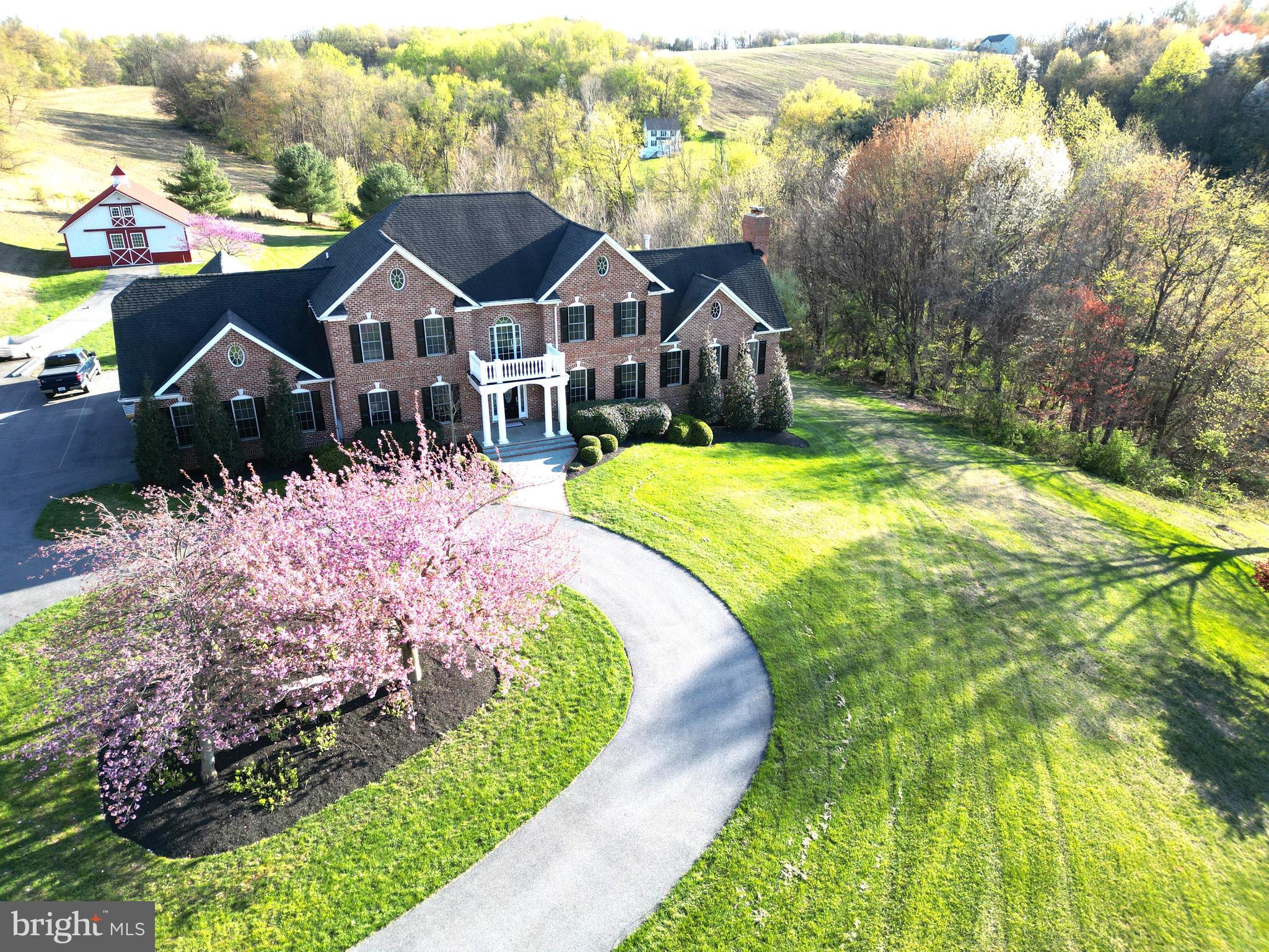a front view of a house with yard and green space