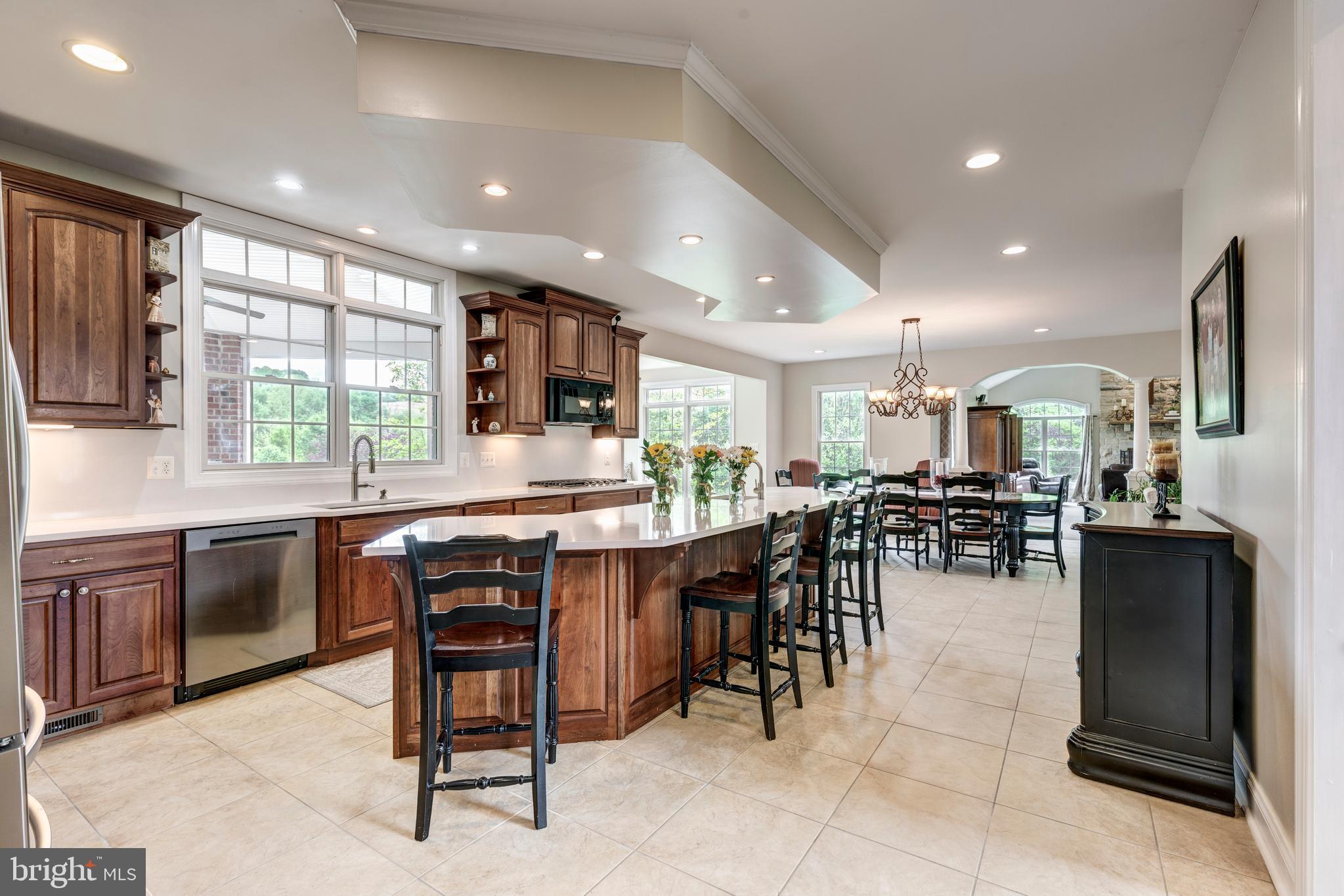 2995 Sams Creek Road New Windsor, MD 21776 - Photo 47 of 126 a kitchen with lots of wooden furniture dining table and stainless steel appliances