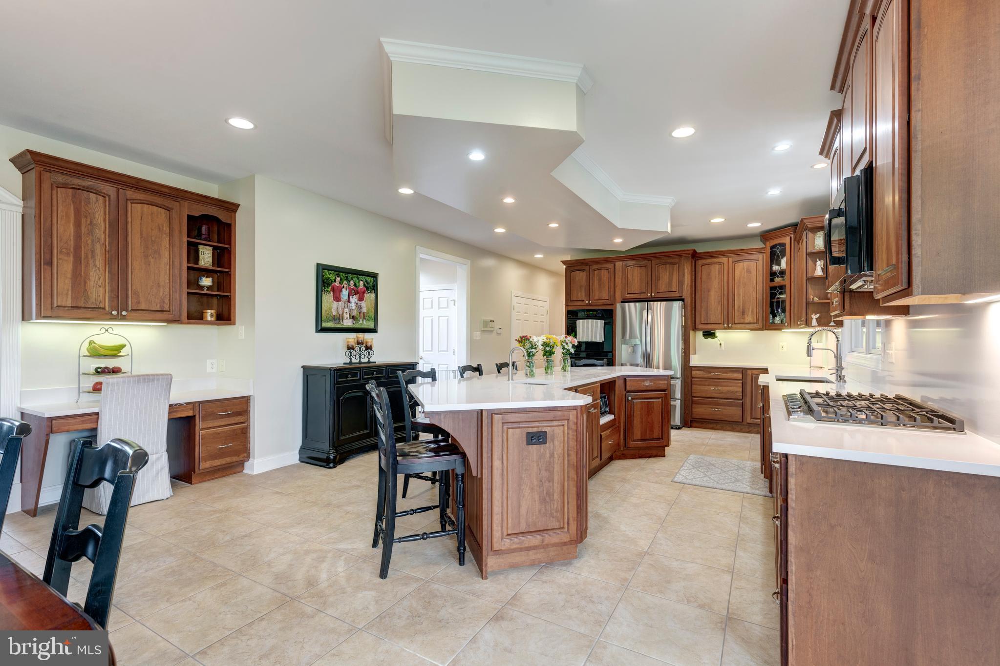 2995 Sams Creek Road New Windsor, MD 21776 - Photo 51 of 126 a kitchen with kitchen island granite countertop lots of counter top space and furniture