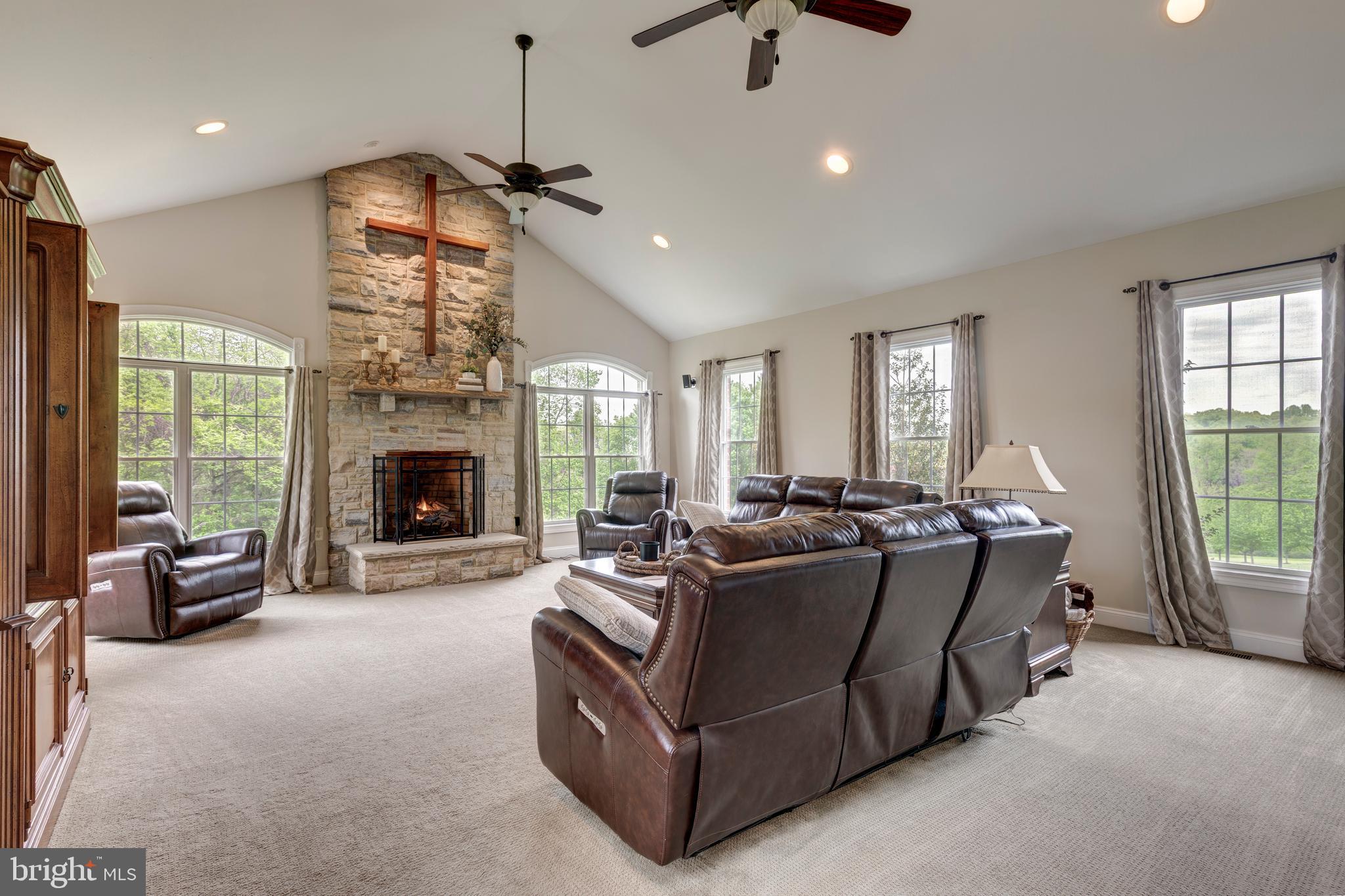 2995 Sams Creek Road New Windsor, MD 21776 - Photo 59 of 126 a living room with furniture a fireplace and a chandelier