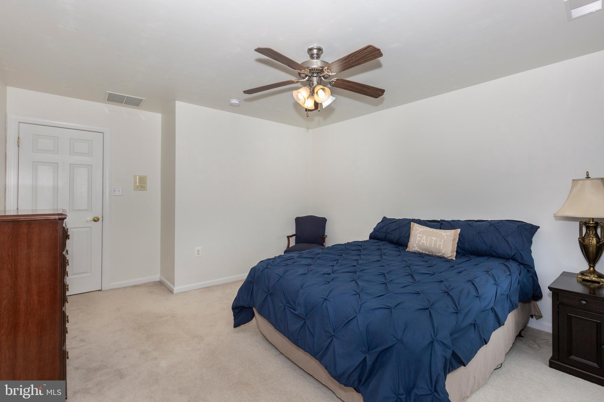 2995 Sams Creek Road New Windsor, MD 21776 - Photo 80 of 126 a bedroom with a bed and a chandelier