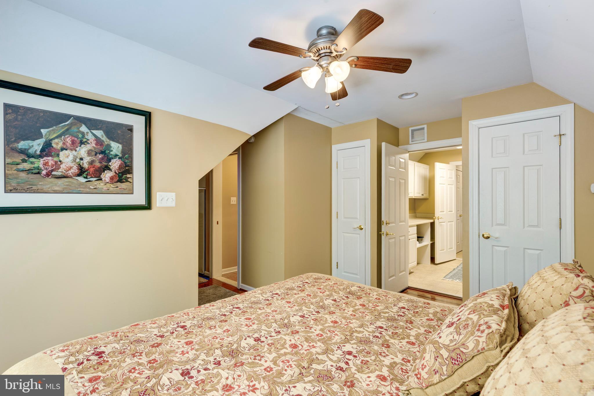2995 Sams Creek Road New Windsor, MD 21776 - Photo 83 of 126 a bedroom with a large bed and a chandelier