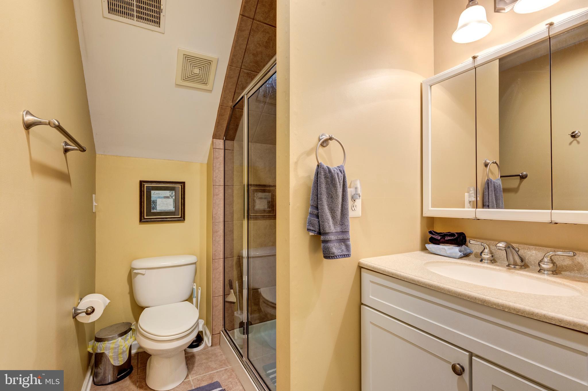 2995 Sams Creek Road New Windsor, MD 21776 - Photo 85 of 126 a bathroom with a granite countertop toilet sink and a mirror