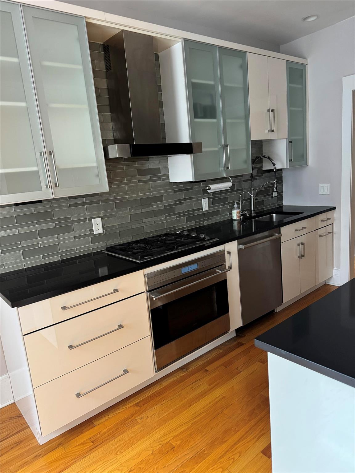 143 Garth Road, Unit 3EF Scarsdale, NY 10583 - Photo 1 of 1 a kitchen with granite countertop a stove and a sink
