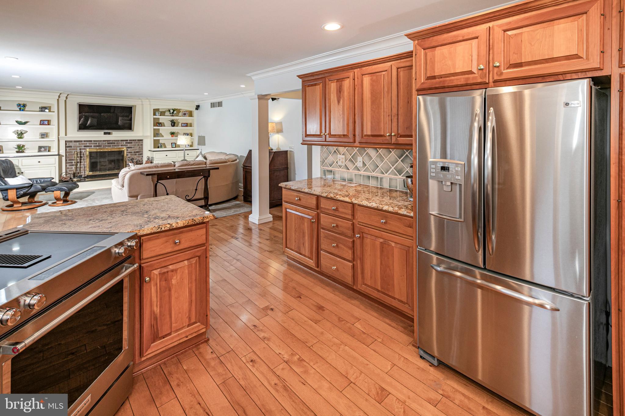 6 Nelson Ridge Road Princeton, NJ 08540 - Photo 15 of 41 a kitchen with stainless steel appliances granite countertop a refrigerator a sink dishwasher and wooden cabinets with wooden floor
